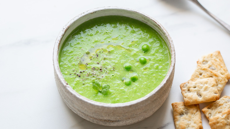 bright green soup in a white bowl