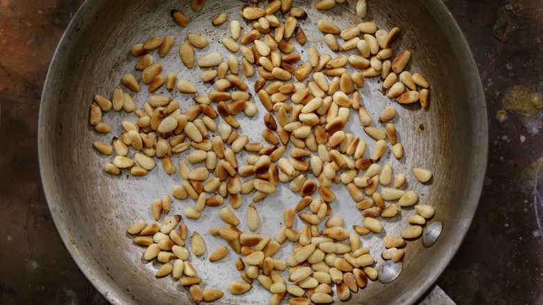 Toasted pine nuts in a pan