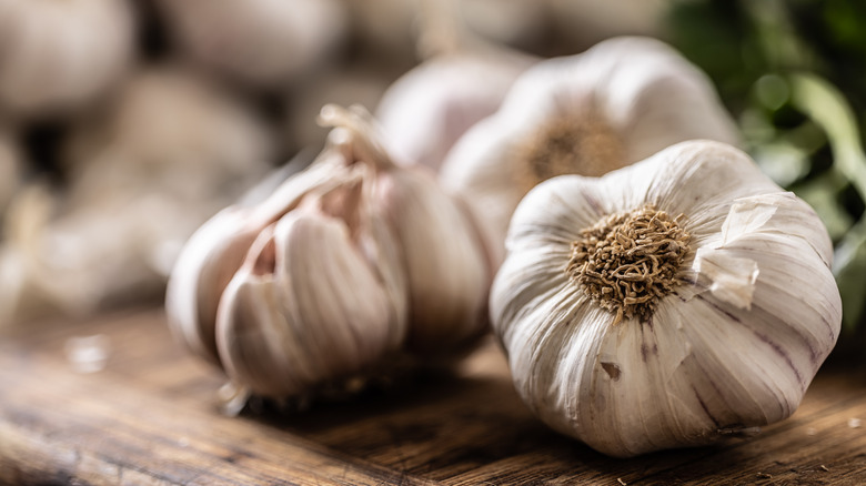 Bulbs of garlic on cutting board