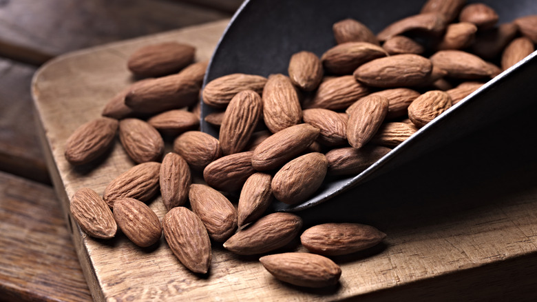 scoop of almonds on cutting board