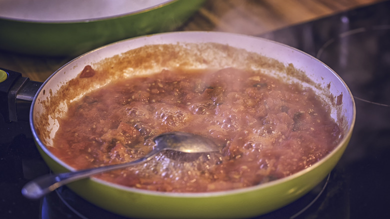 Tomato sauce simmering on stove