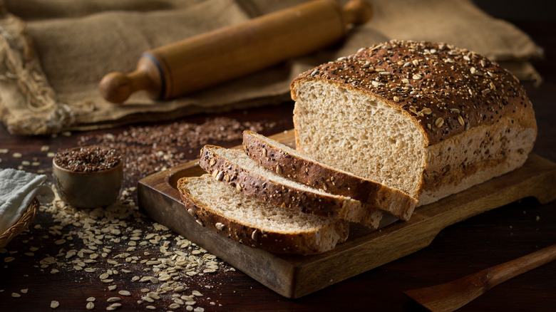 sliced loaf of bread with seeds and oats