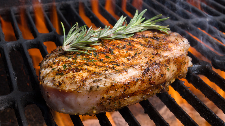 Pork chop on the grill with rosemary