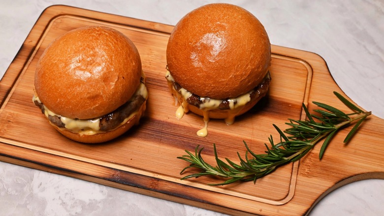 burgers on wood board