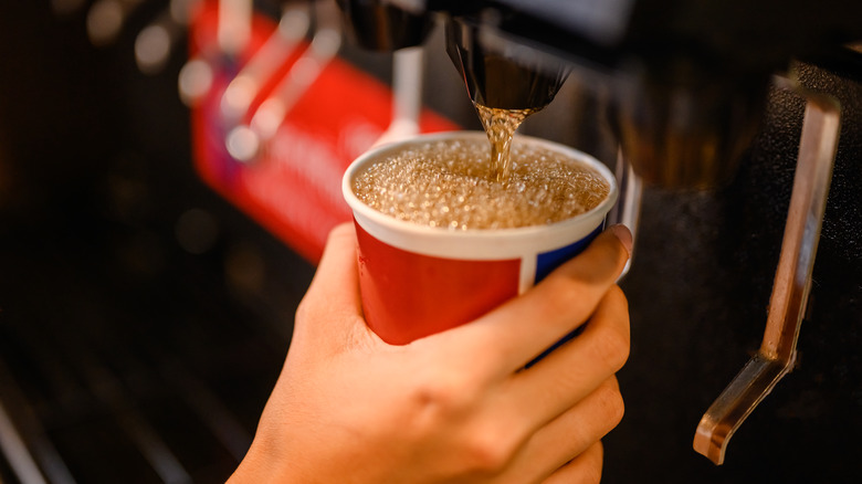 pouring soda from a machine