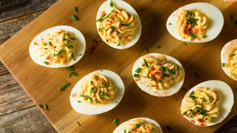 deviled eggs on a cutting board