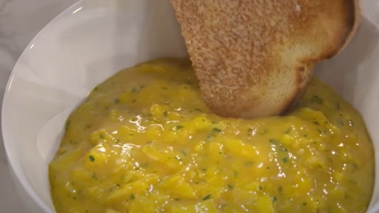 French-style scrambled eggs in a bowl with toast