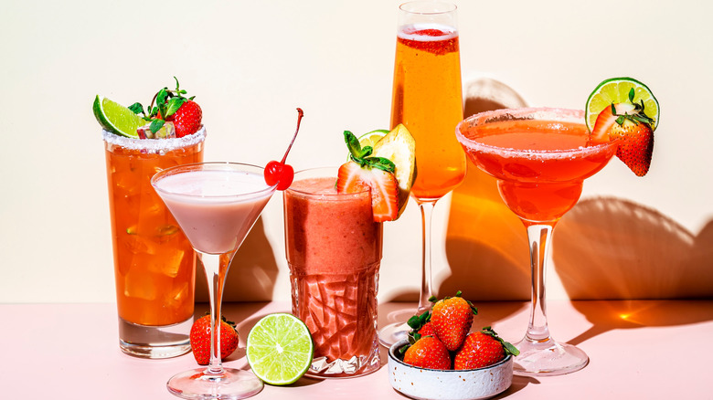 Assortment of fruity red drinks in a variety of cocktail glasses