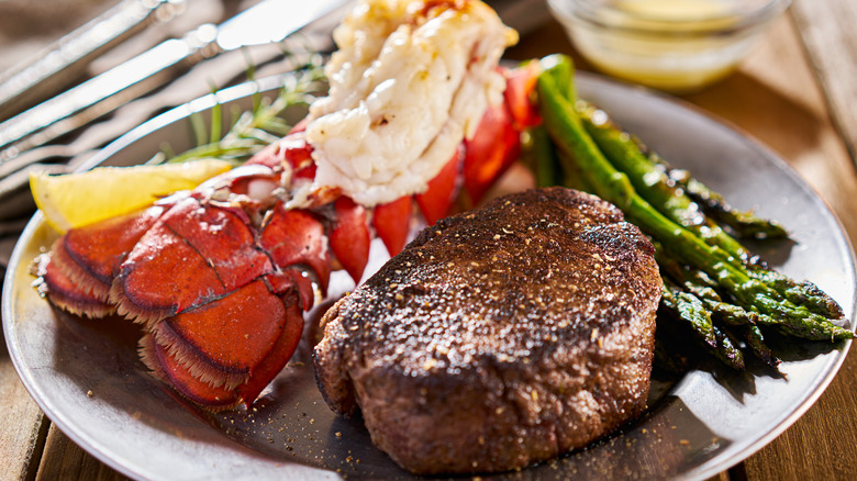 Steak and lobster on a plate with asparagus
