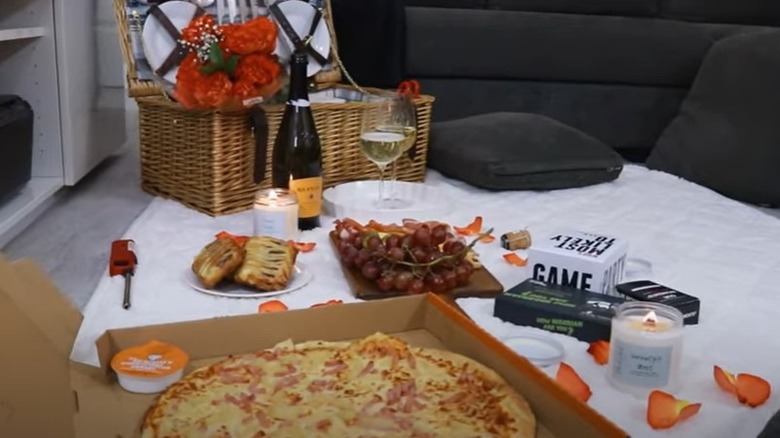 Indoor picnic with pizza and champagne