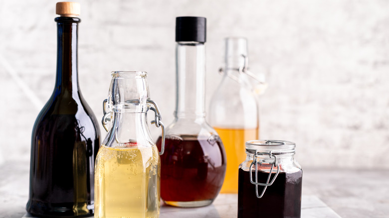 Various types of vinegar in glass bottles