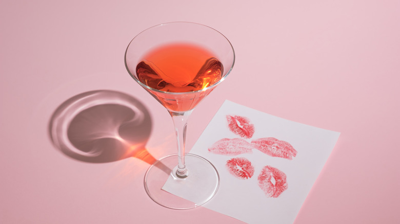 Cocktail glass with lipstick marks on napkin