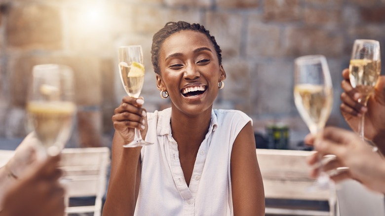 People raising flutes of sparkling wine