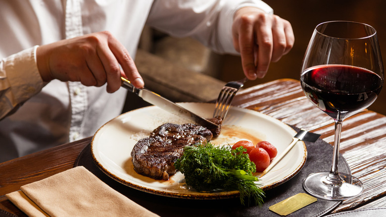 Organized plate with steak, tomatoes, and greens