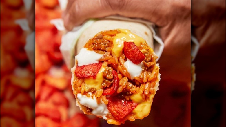 hand holding beefy crunch burrito