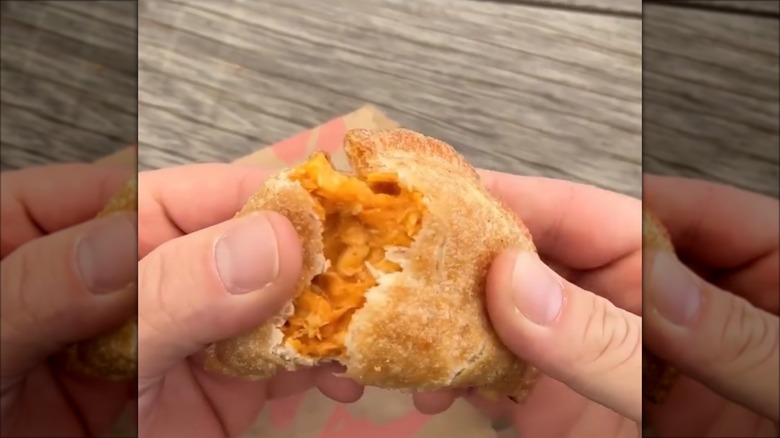 Cheesy chicken crispanada torn in half