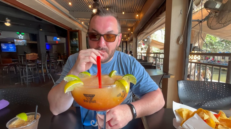 man drinking 60 ounce margarita 