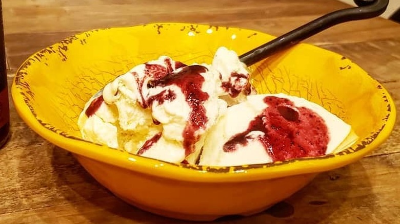 bowl of ice cream topped with hot sauce