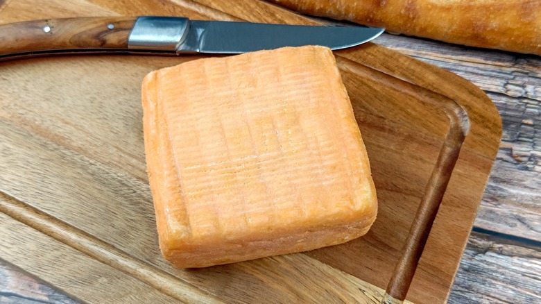 Maroilles cheese on wooden board