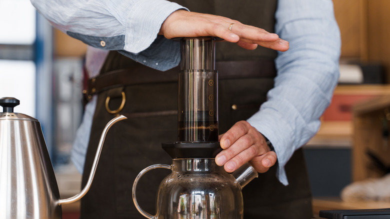 Person using Aeropress espresso maker