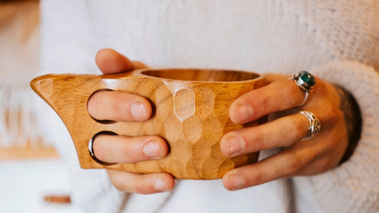 Hands holding coffee mug