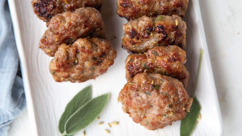 Sausage patties with green leaves