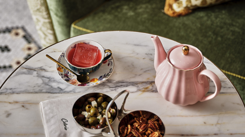 Tea set and appetizers on marble table 