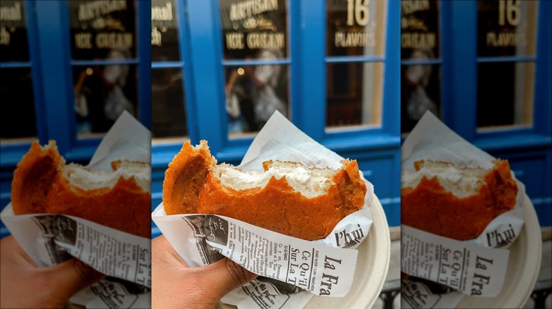 Hand holding brioche ice cream plate