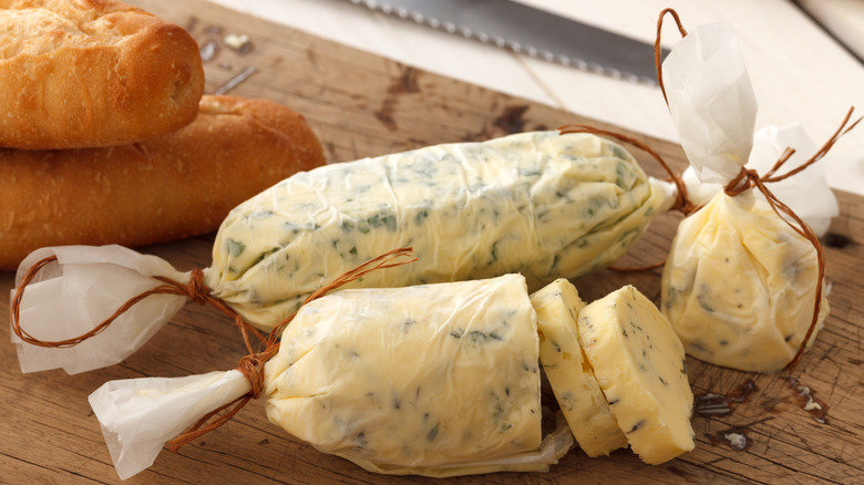 Compound butter on cutting board with bread