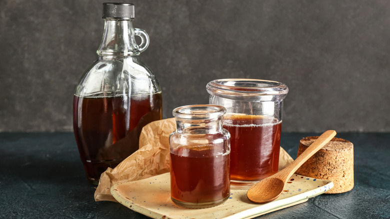 A bottle and two jars of maple syrup