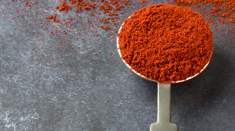 Measuring spoon overflowing with paprika