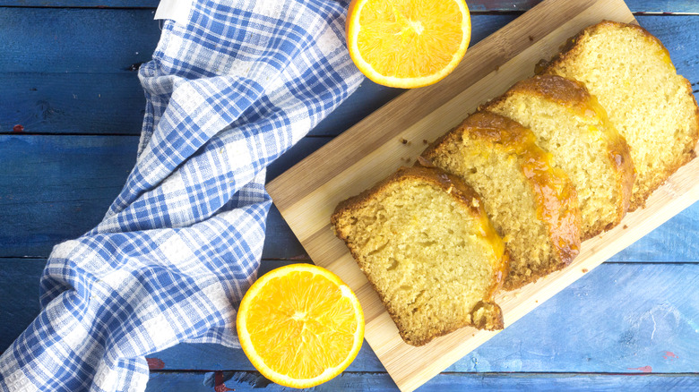 orange loaf cake sliced wooden cutting board