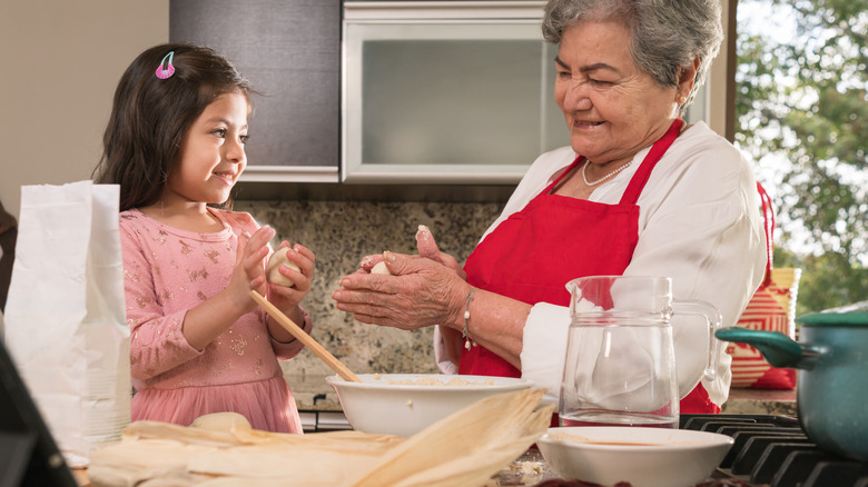 Family members making masa together