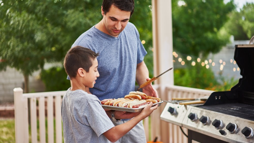 Dad and son cooking burgers