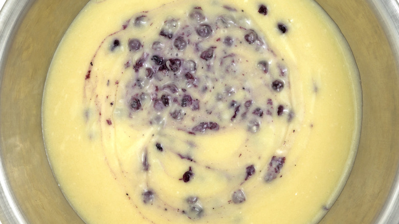 Bowl with batter with blueberry streaks in it