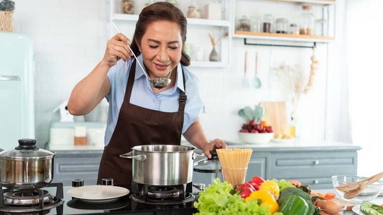 woman tasting soup