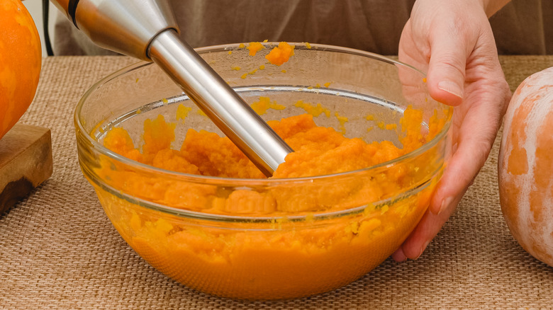 mixing pumpkin batter in bowl