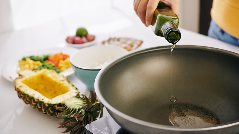 oil being poured into a wok