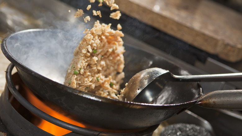 rice being fried in a wok