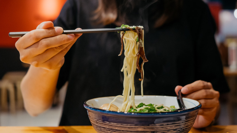 Person eating ramen