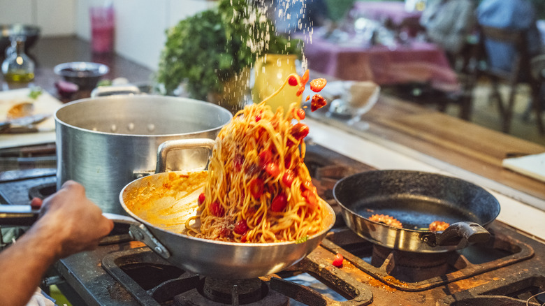 Pasta tossed in pan