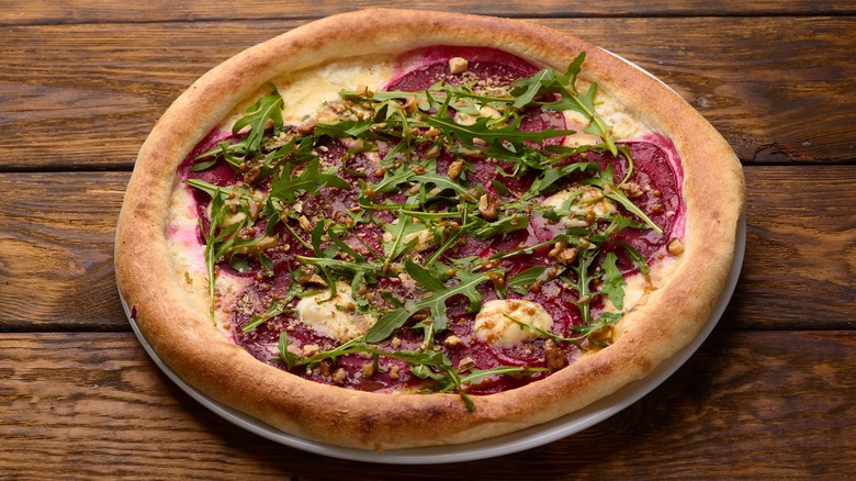 beet pizza with gorgonzola on wooden table