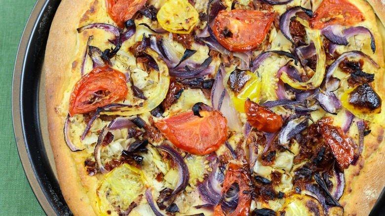 hummus and vegetable pizza on tray