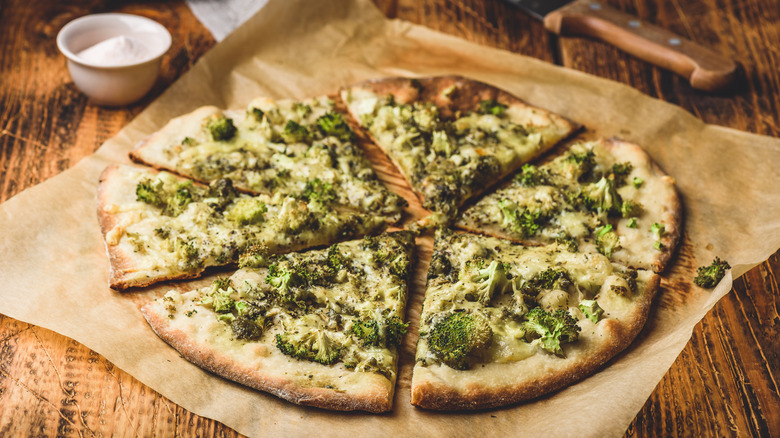 pesto pizza with broccoli on paper