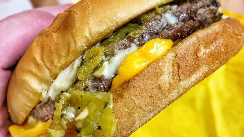 Hand holding Whataburger cheeseburger