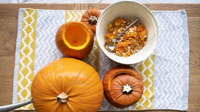 pumpkins and bowl of pumpkin pulp