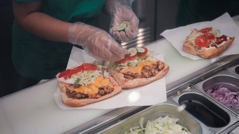 subway employee making sandwich