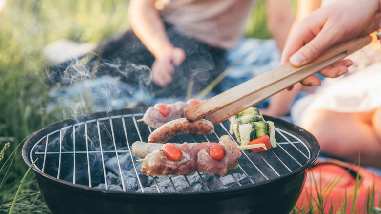 Hand grilling sausages