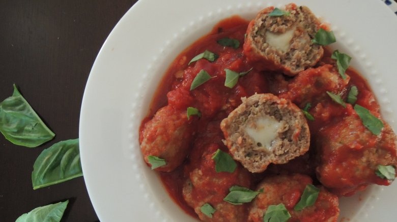 Meatballs in tomato sauce with cheese centers