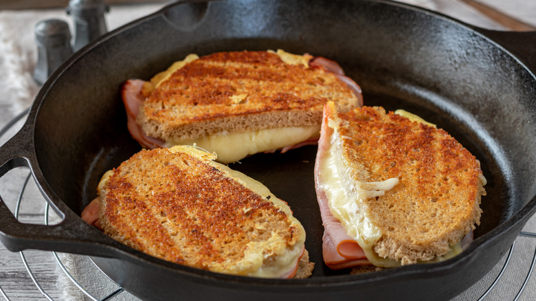 Grilled cheese and ham sandwiches in skillet